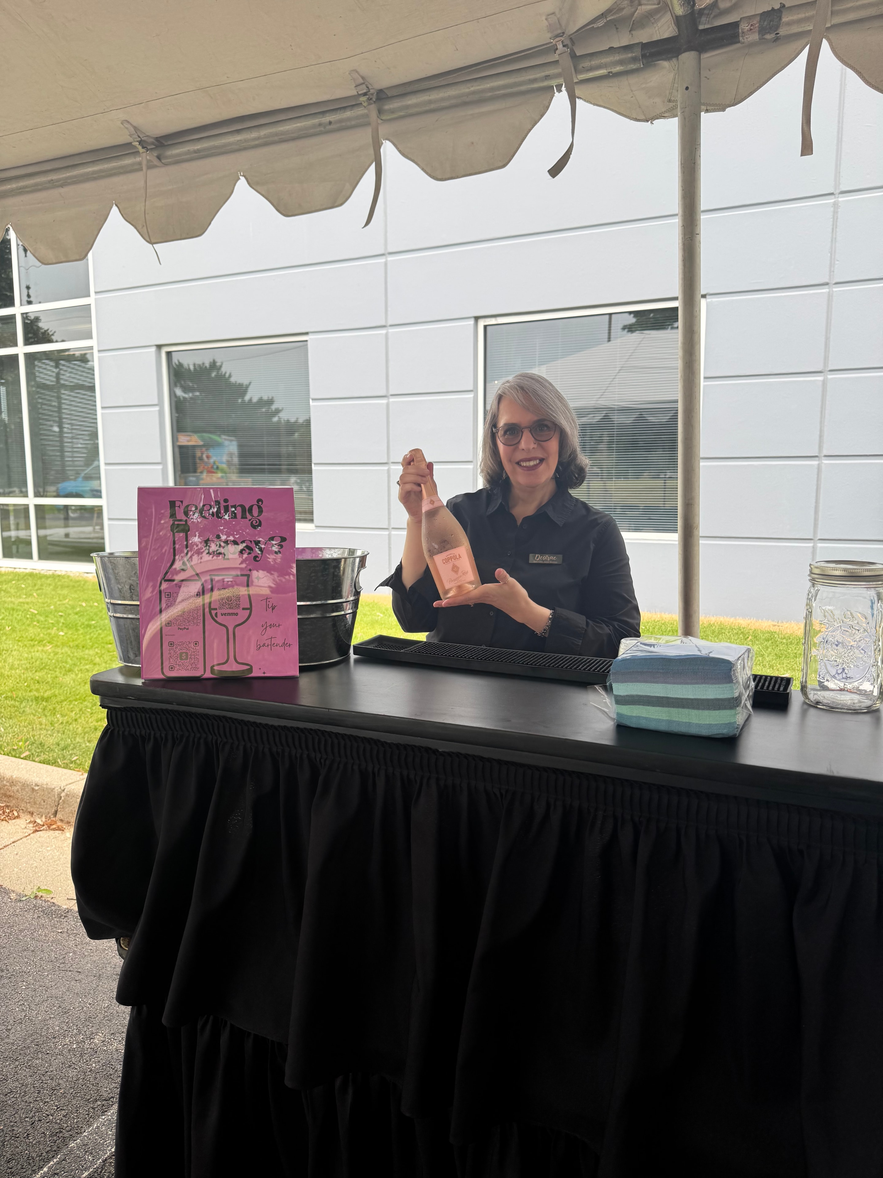 Desirae smiling and serving drinks at the Pleasant Prairie corporate event
