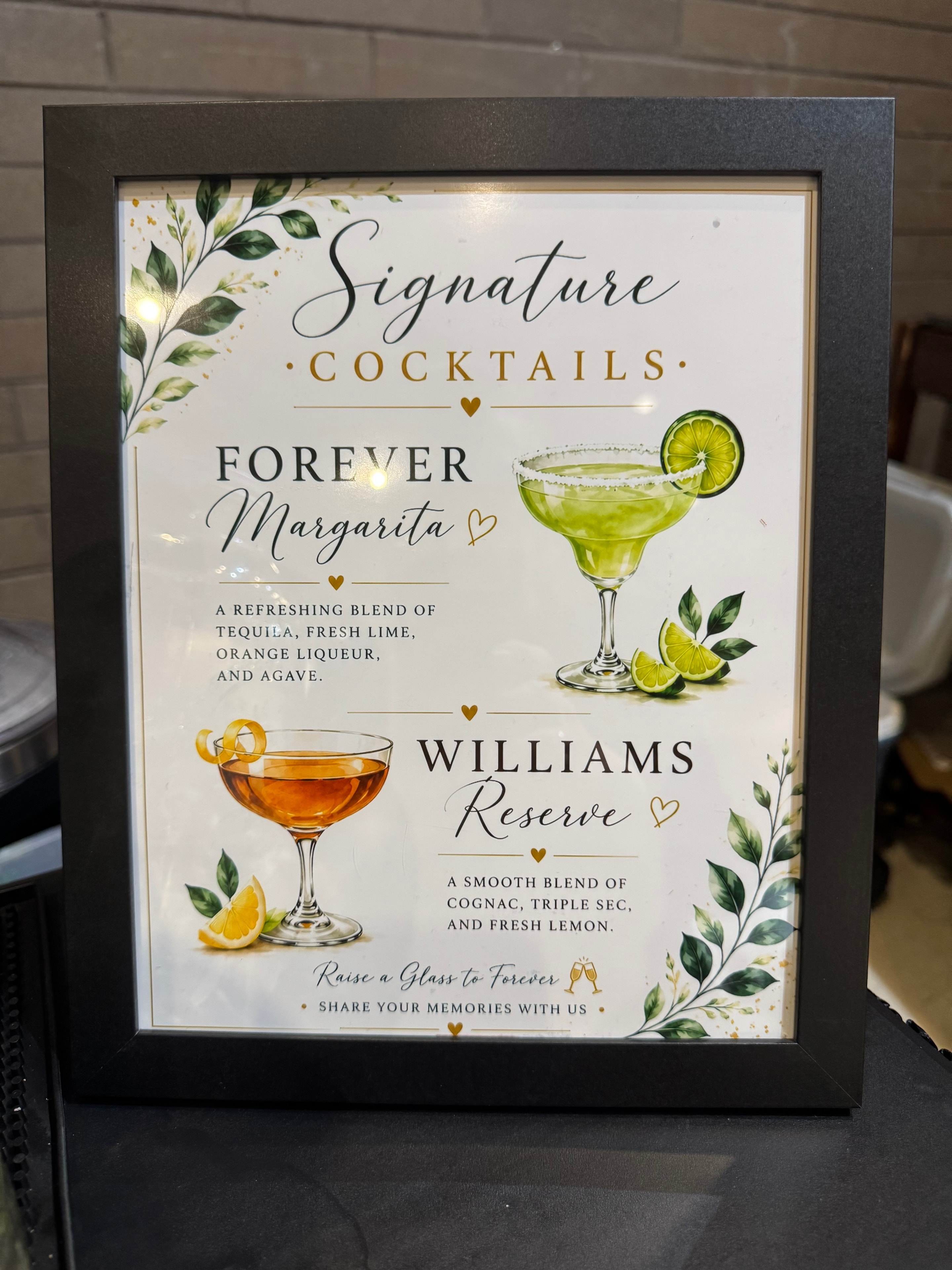 Framed signature cocktails menu featuring Forever Margarita and Williams Reserve with botanical illustrations