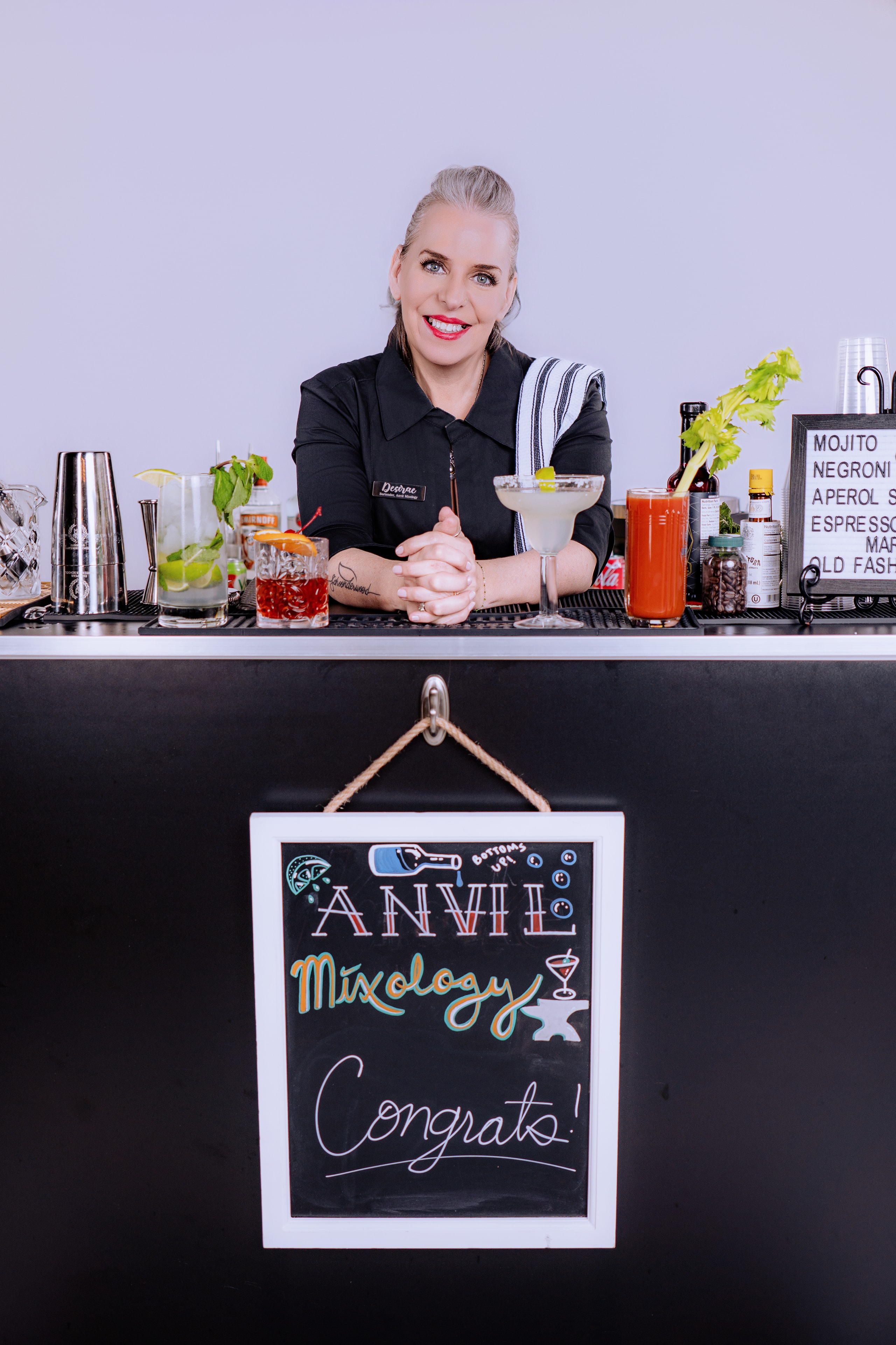 Desirae, owner of Anvil Mixology MKE, behind the bar